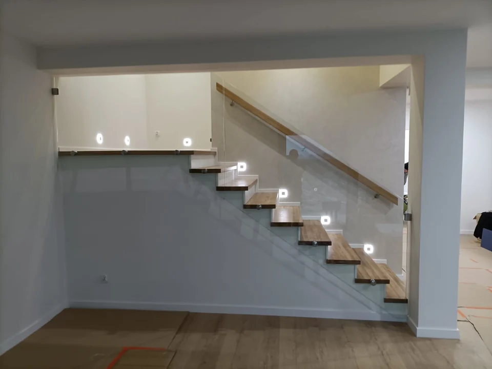 Schody na beton z oświetleniem LED i szklaną balustradą